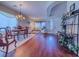 Open-concept living and dining area with hardwood floors, elegant chandelier, and bright natural light at 7225 Millerbird St, North Las Vegas, NV 89084