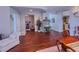Spacious living area with hardwood floors, a comfortable lounge chair, and views of the dining area at 7225 Millerbird St, North Las Vegas, NV 89084