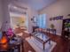 Elegant living area with neutral walls, dark wood flooring, and decorative artwork on the walls at 7225 Millerbird St, North Las Vegas, NV 89084