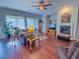 Relaxing living room featuring hardwood floors, a fireplace, and ample natural light streaming through sheer curtains at 7225 Millerbird St, North Las Vegas, NV 89084