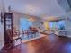 Open-concept living and dining area with elegant chandelier and hardwood flooring at 7225 Millerbird St, North Las Vegas, NV 89084