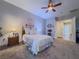 Comfortable carpeted main bedroom featuring ceiling fan and access to the ensuite bathroom at 7225 Millerbird St, North Las Vegas, NV 89084