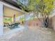 Covered patio with outdoor furniture, decorative rock landscaping, and stone pillars at 7225 Millerbird St, North Las Vegas, NV 89084