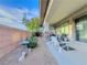 Covered patio with outdoor seating and desert landscaping, perfect for entertaining and relaxing at 7225 Millerbird St, North Las Vegas, NV 89084