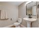 A cozy bathroom featuring a modern sink with black faucet and a toilet with a fresh white finish at 7761 Cowboy Trl, Las Vegas, NV 89131