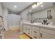 Bright bathroom with double sink vanity, large mirror, and updated fixtures at 7761 Cowboy Trl, Las Vegas, NV 89131