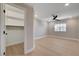 Large bedroom with a ceiling fan, hardwood floors, closet, and good natural light at 7761 Cowboy Trl, Las Vegas, NV 89131