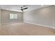Spacious bedroom features light wood flooring, ceiling fan, window, and neutral walls at 7761 Cowboy Trl, Las Vegas, NV 89131