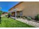 Beautiful side exterior with green grass, an awning and beautiful landscaping at 7761 Cowboy Trl, Las Vegas, NV 89131