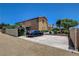 Exterior view of the house, featuring a long driveway, landscaping, and two story architecture at 7761 Cowboy Trl, Las Vegas, NV 89131