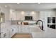 Bright kitchen featuring white cabinets, stone countertops, stainless appliances, and modern fixtures at 7761 Cowboy Trl, Las Vegas, NV 89131