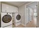 Modern laundry room with new washer and dryer, updated cabinetry, and natural light at 7761 Cowboy Trl, Las Vegas, NV 89131