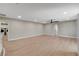 Open living room featuring a modern ceiling fan and wood floors, with laundry room access at 7761 Cowboy Trl, Las Vegas, NV 89131