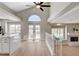 Open-concept living area with a kitchen, fireplace, bright windows, and outside views at 7761 Cowboy Trl, Las Vegas, NV 89131