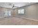 Bright living room with a ceiling fan, natural light, and access to the backyard creating a relaxing atmosphere at 7761 Cowboy Trl, Las Vegas, NV 89131