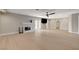 Spacious living room with light wood flooring, fireplace, and a ceiling fan for added comfort at 7761 Cowboy Trl, Las Vegas, NV 89131