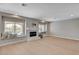 Bright living room with a fireplace, large windows with window seating, and neutral tones at 7761 Cowboy Trl, Las Vegas, NV 89131