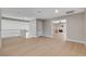 An open living space featuring hardwood floors, a railing, and views into adjacent rooms with a fireplace at 7761 Cowboy Trl, Las Vegas, NV 89131