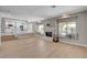 Inviting living room with fireplace, large windows, and an open flow to the kitchen at 7761 Cowboy Trl, Las Vegas, NV 89131