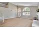 A spacious living room with hardwood flooring, large arched windows, and a stylish fireplace at 7761 Cowboy Trl, Las Vegas, NV 89131