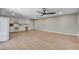 Spacious living room with a ceiling fan, built-in desk, and modern flooring providing a cozy atmosphere at 7761 Cowboy Trl, Las Vegas, NV 89131