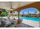 Charming covered patio overlooking the pool with comfortable seating and a spiral staircase at 7761 Cowboy Trl, Las Vegas, NV 89131
