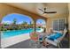 Relaxing covered patio with pool views, comfortable seating, and a peaceful outdoor ambiance at 7761 Cowboy Trl, Las Vegas, NV 89131