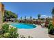 Relaxing backyard pool surrounded by lush greenery and seating, perfect for outdoor living at 7761 Cowboy Trl, Las Vegas, NV 89131