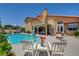 A relaxing backyard pool area with chairs at 7761 Cowboy Trl, Las Vegas, NV 89131