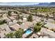 An aerial view shows a neighborhood with many houses, and surrounding roads at 8428 Apple Hill Ct, Las Vegas, NV 89128