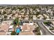 An aerial view shows a community with many houses, streets, and desert landscaping at 8428 Apple Hill Ct, Las Vegas, NV 89128