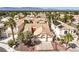 An aerial view of the property features its desert landscaping, tiled roof, and neighborhood at 8428 Apple Hill Ct, Las Vegas, NV 89128