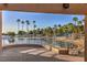 Sandy beach with clear water, palm trees, lifeguard stand, and a relaxing waterfront vibe at 8428 Apple Hill Ct, Las Vegas, NV 89128