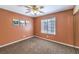 Neutral bedroom with a ceiling fan, window with blinds and scenic artwork adorning the walls at 8428 Apple Hill Ct, Las Vegas, NV 89128