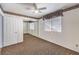 Bedroom with neutral walls, carpeted floor, closet with mirror doors, and ceiling fan at 8428 Apple Hill Ct, Las Vegas, NV 89128