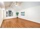Spacious bedroom with hardwood floors, a vaulted ceiling, and a large arched window providing natural light at 8428 Apple Hill Ct, Las Vegas, NV 89128