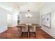 Elegant dining room with modern chandelier and hardwood flooring at 8428 Apple Hill Ct, Las Vegas, NV 89128