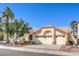 Charming single-story home featuring a three-car garage, desert landscaping, and a tiled roof at 8428 Apple Hill Ct, Las Vegas, NV 89128