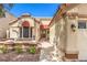Beautiful front exterior featuring a tiled roof, desert landscaping, and a covered entryway at 8428 Apple Hill Ct, Las Vegas, NV 89128