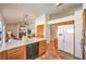 Open kitchen featuring wood cabinets, tiled floor, a large refrigerator, and an island overlooking the living area at 8428 Apple Hill Ct, Las Vegas, NV 89128
