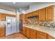 Large kitchen features warm wood cabinetry, tile floors, and stainless appliances at 8428 Apple Hill Ct, Las Vegas, NV 89128