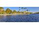 Picturesque view of a lake with lush surroundings, featuring palm trees and recreational areas at 8428 Apple Hill Ct, Las Vegas, NV 89128