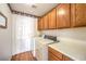 Functional laundry room with washer, dryer, storage cabinets, and a convenient countertop at 8428 Apple Hill Ct, Las Vegas, NV 89128