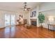 Bright living room features hardwood floors, a cozy fireplace, and access to the backyard through French doors at 8428 Apple Hill Ct, Las Vegas, NV 89128