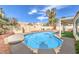 Backyard oasis with a sparkling pool, lush landscaping, and a relaxing atmosphere at 8428 Apple Hill Ct, Las Vegas, NV 89128