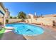 Inviting pool area with a unique shape, mature landscaping, and a serene setting at 8428 Apple Hill Ct, Las Vegas, NV 89128