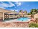 Relaxing backyard with a sparkling pool, ample patio space, and lush greenery at 8428 Apple Hill Ct, Las Vegas, NV 89128