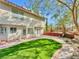 Expansive backyard offers a well-manicured lawn, mature trees, and a serene ambiance for outdoor activities and relaxation at 8632 Skyward Ct, Las Vegas, NV 89145