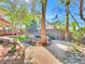 Lush backyard featuring mature trees, rock features and a winding walkway at 8632 Skyward Ct, Las Vegas, NV 89145