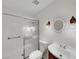 Well lit bathroom features a tile shower with a sliding glass door, and a decorative mirror and vanity at 8632 Skyward Ct, Las Vegas, NV 89145